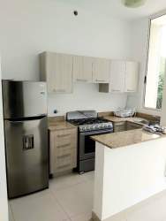 Laundry room with stacked washer dryer utility sink in Costa Verde apartment Panama