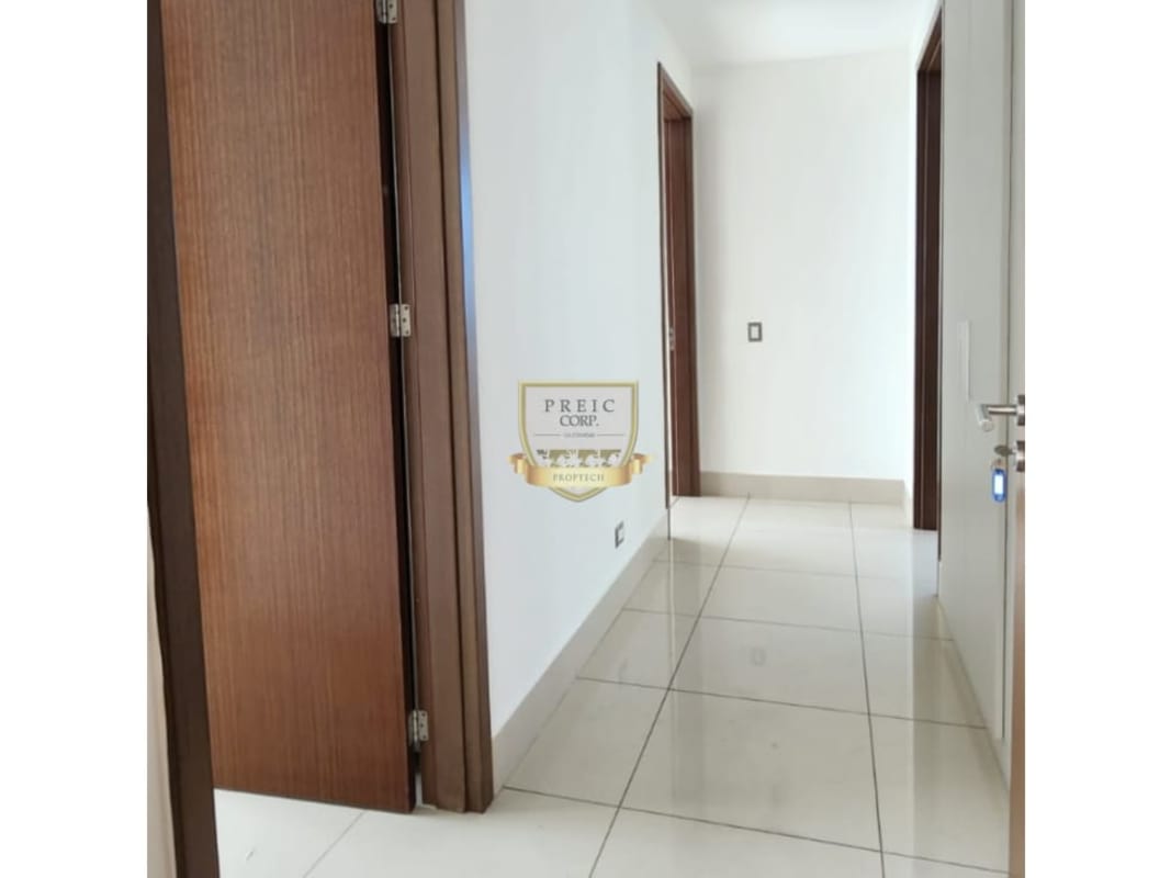 Modern hallway with ceramic floors and wood door frames in PH Ocean Two luxury apartment Panama City