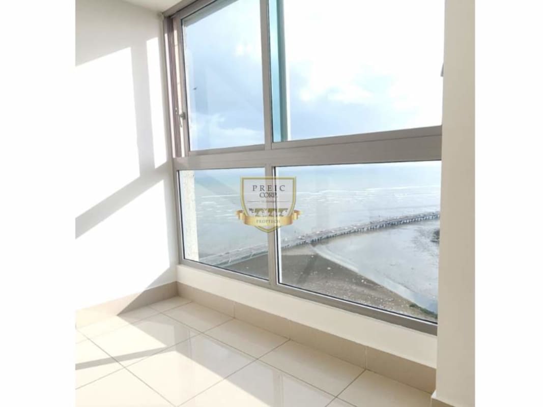 Bright enclosed balcony with panoramic Pacific Ocean and pier views natural daylight PH Ocean Two Costa del Este Panama