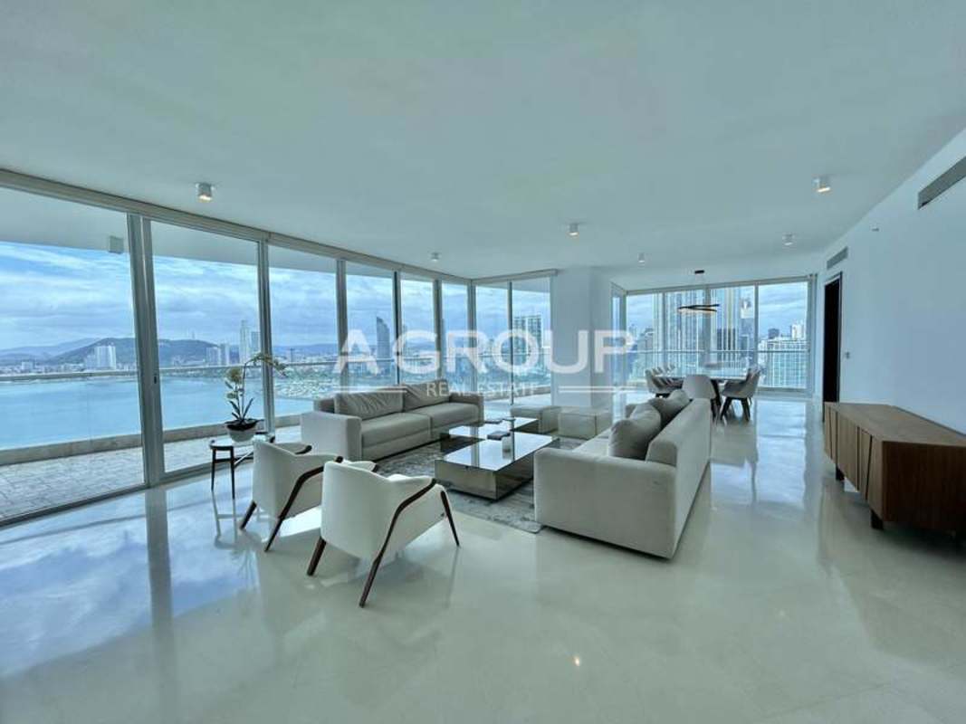 Modern open plan living dining panoramic windows ocean and skyline views The Point Panama