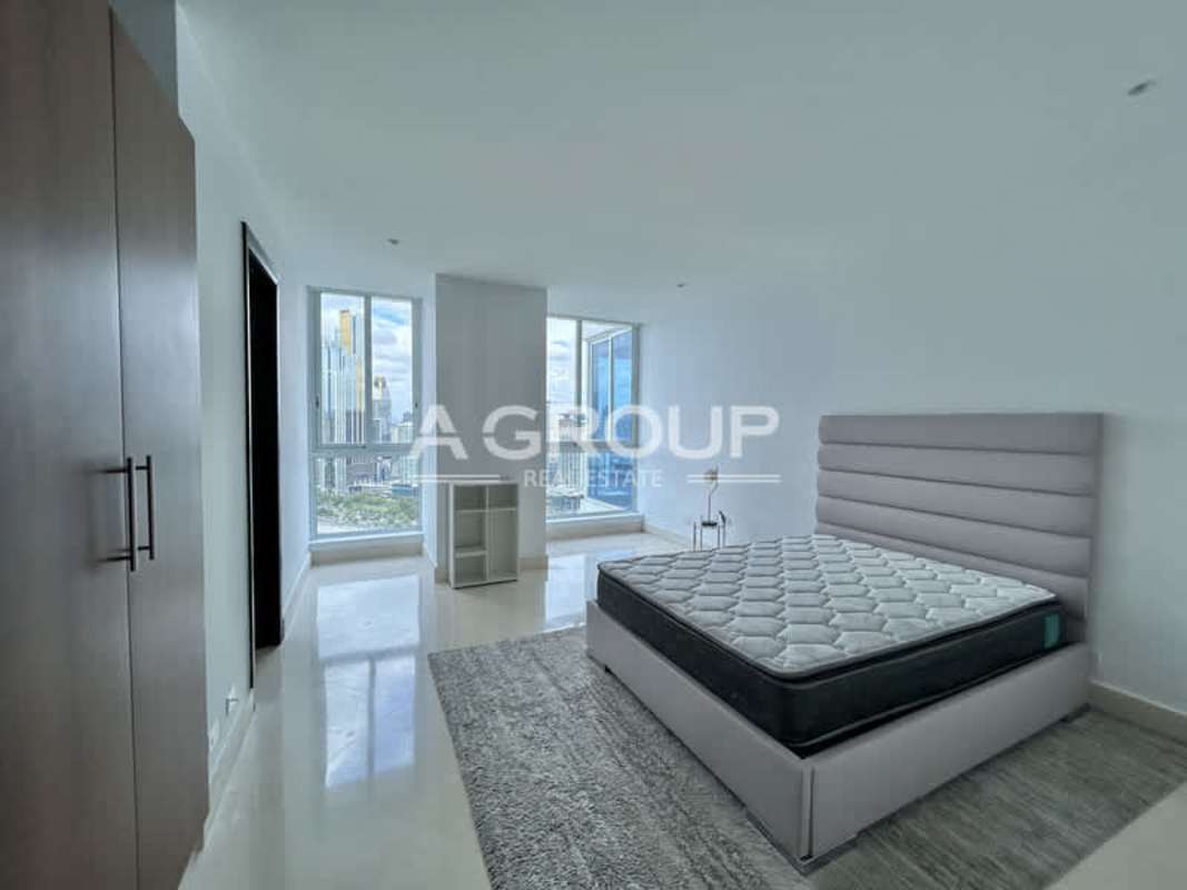 Minimalist master bedroom with skyline view floor-to-ceiling windows in The Point Punta Paitilla Panama