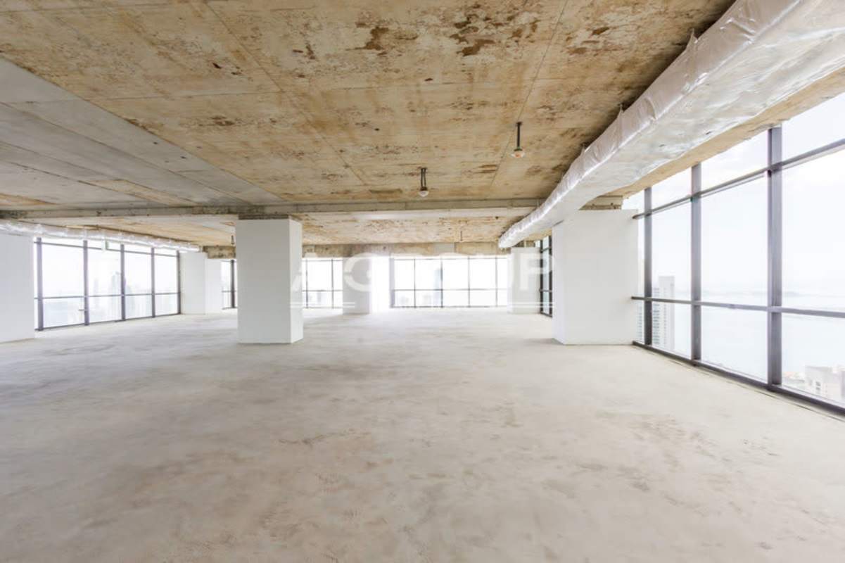 Unfinished open plan office with exposed ceiling and floor-to-ceiling windows at Tower Financial Center Panama