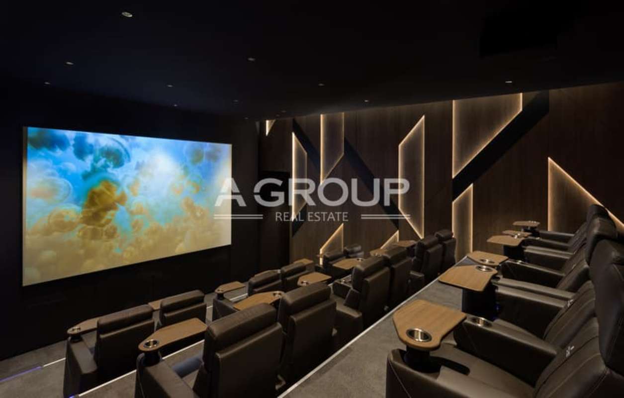 Luxury home theater with tiered recliners, projection screen, accent lighting in The Towers Panama