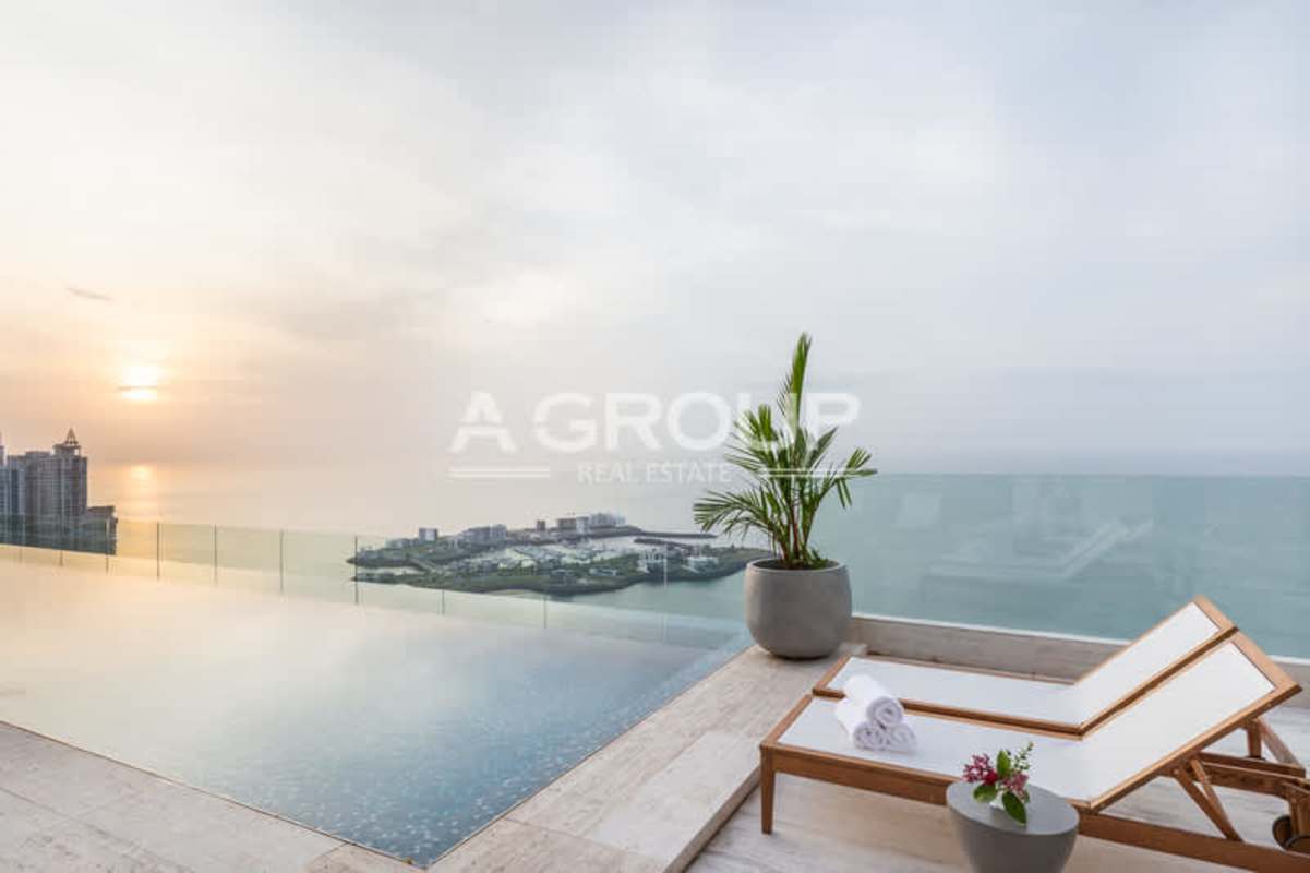 Rooftop infinity pool overlooking Pacific Ocean and skyline at sunset in The Towers Punta Paitilla Panama
