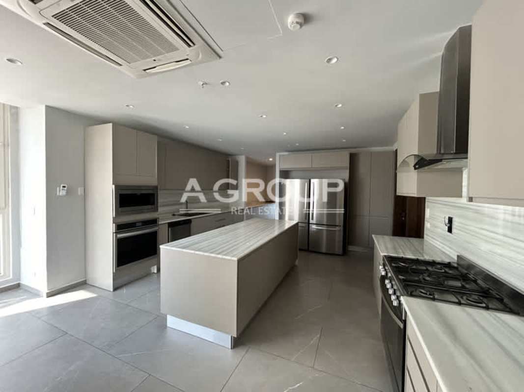 Spacious luxury kitchen with marble island, stainless appliances, window at The Towers Punta Paitilla Panama