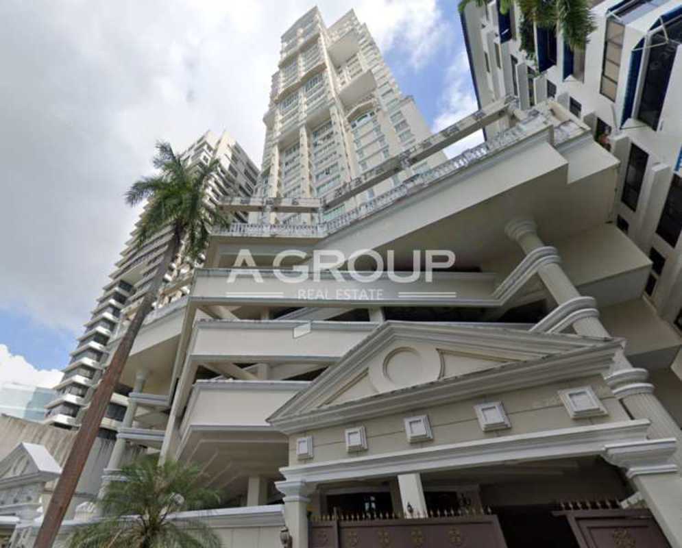 Exterior of PH Balboa Tower luxury condominium high-rise with neoclassical elements and palm landscaping on Avenida Balboa Panama City