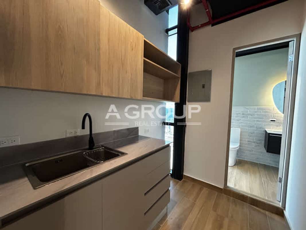 Open workspace with wood floors, workstations and glass walls in PH Financial Center Calle 50 Panama