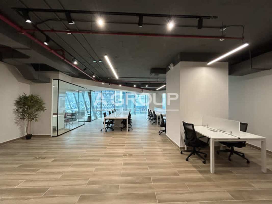 Spacious open-plan office with floor-to-ceiling windows, exposed ceiling, desks in Financial Park Costa del Este Panama