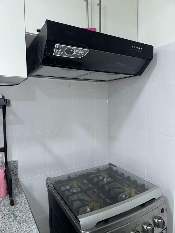 Apartment kitchen with stove, extractor hood, tile backsplash Residences San Cristobal Panama