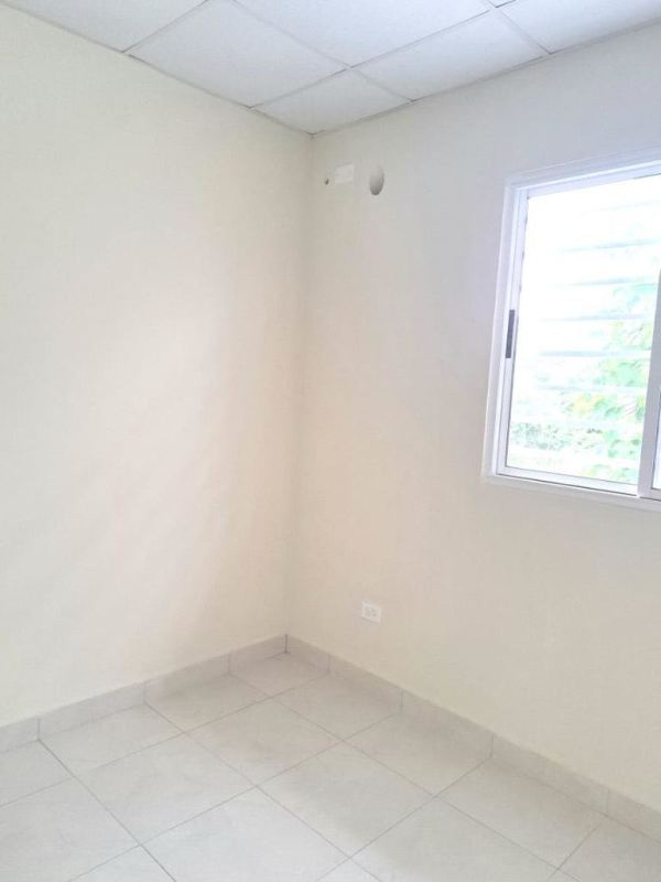 Bright empty bedroom with tiled flooring minimalist design Residences San Cristobal