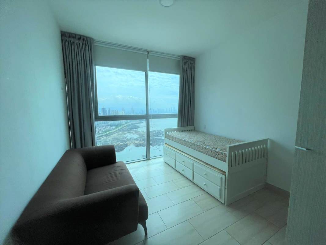 Bedroom in Grand Tower Punta Pacifica with large window city skyline tile flooring Panama luxury apartment