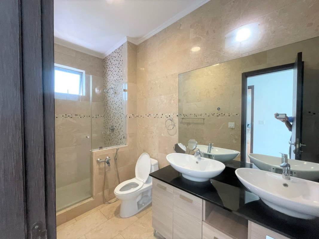 Modern luxury bathroom with marble tiles double sinks glass shower in Grand Tower Punta Pacifica Panama City
