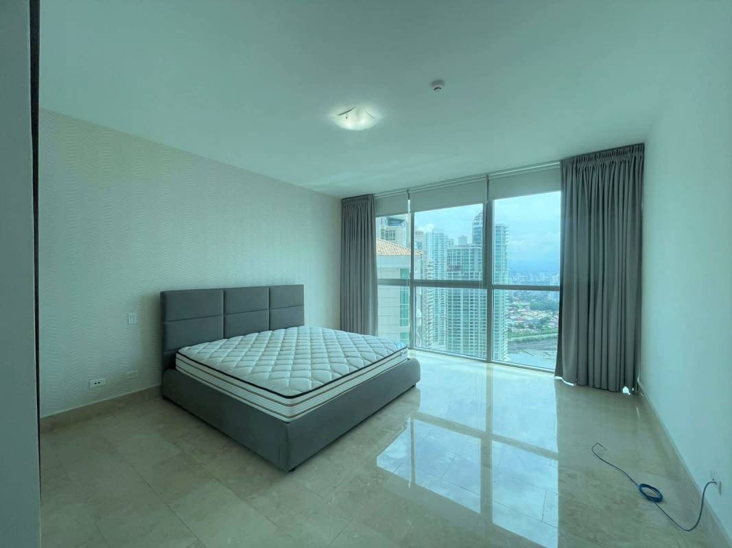 Modern bedroom with built-in closets floor-to-ceiling windows Grand Tower Punta Pacifica Panama City