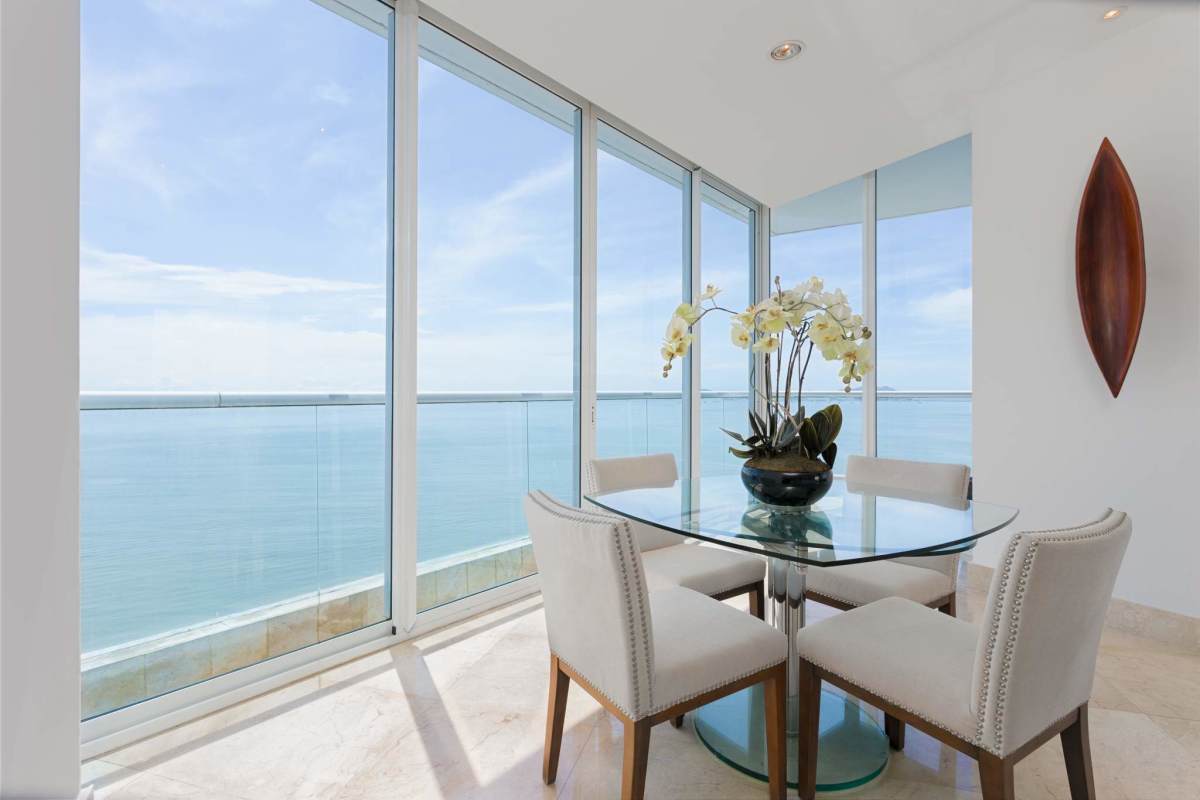 Dining space with panoramic city skyline and ocean views at The Point Tower Panama