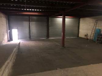 Wide warehouse with large rolling shutter doors for trucks inside Zona Libre Colon Panama