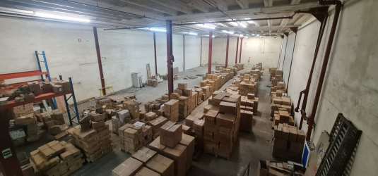 Warehouse interior with stacked boxes and industrial shelving Zona Libre Colon Panama