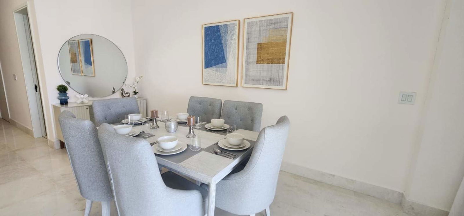 Contemporary dining room with marble floors and artwork at Beach Club Residences Ocean Reef Panama