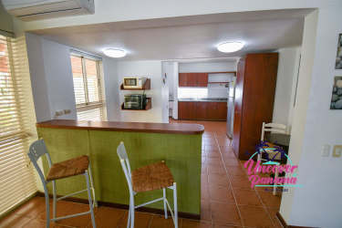 Large covered veranda facing gardens and lake in Costa Blanca Golf & Villas townhouse Panama