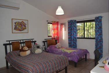 Spacious covered outdoor terrace area with garden views in luxury Coronado residence