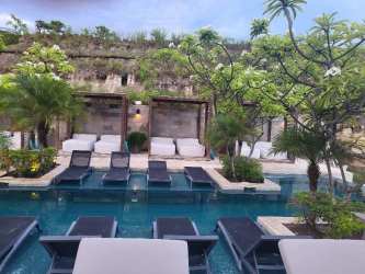 Tropical pool area with cabanas, loungers and lush landscaping at Punta Caelo Panama