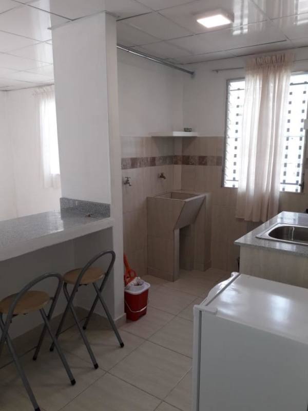 Compact kitchenette area with granite countertop, sink and laundry space Villa Serena Panama