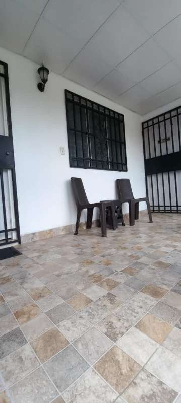 Exterior porch with tiled floors, metal security bars and seating in Villa Serena Panama