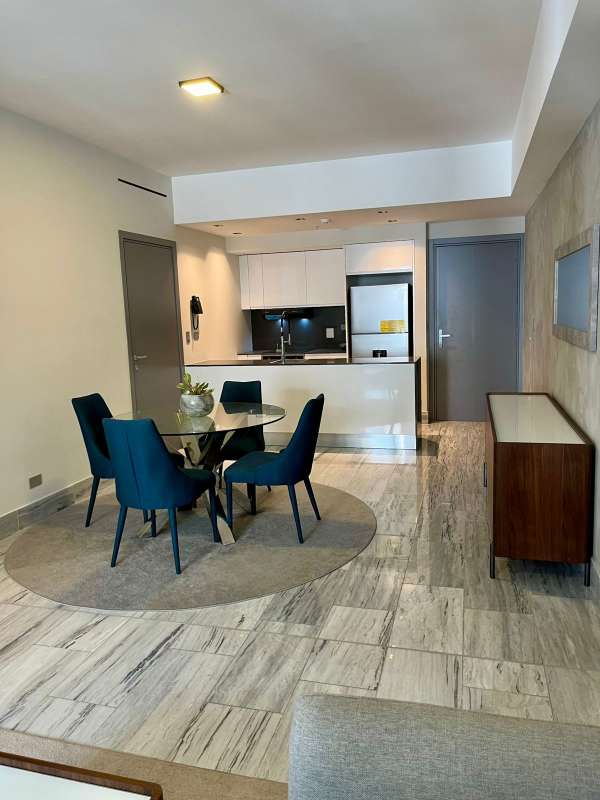 Open modern kitchen and dining with marble floors PH Nuovo by Armani Panama