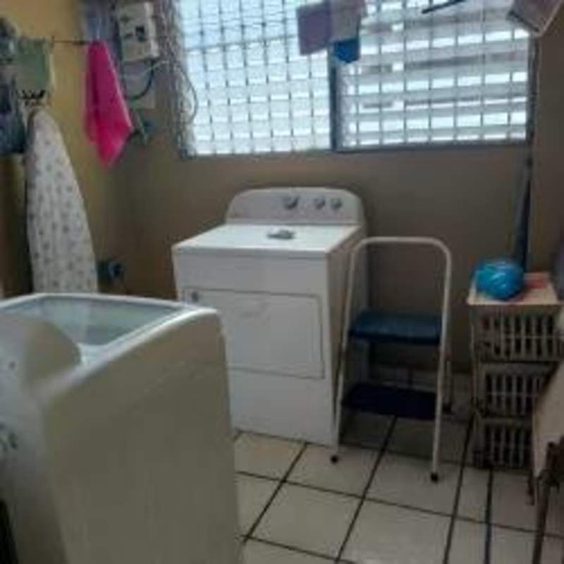 Bright laundry area with window and appliances in PH Parque Dorado El Dorado Panama