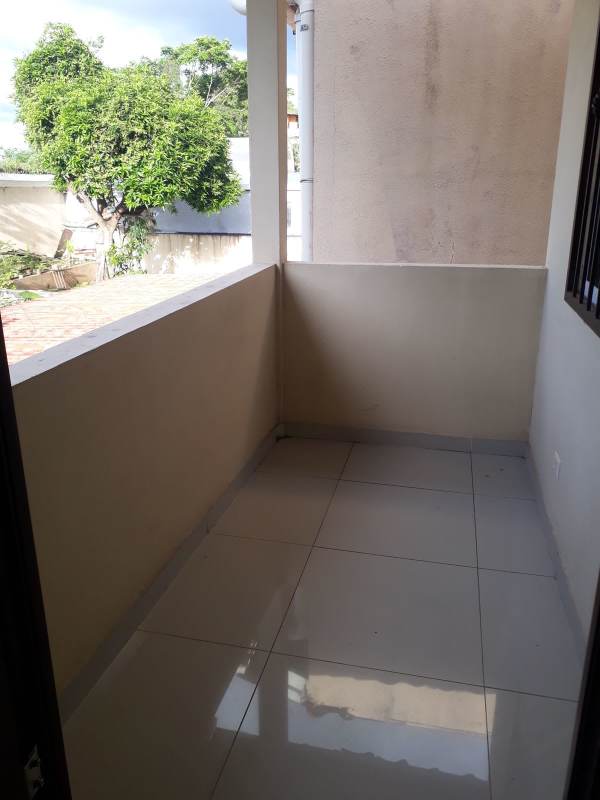 Wood dining table chandelier window grille tile floor in Altavista Home El Bosque Panama City