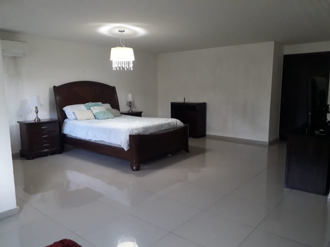 Covered balcony tiled floor overlooks private garden at Altavista Residences El Bosque Panama