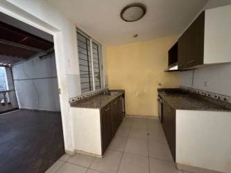 Compact half guest bathroom with pedestal sink and tiled walls in Arraiján gated home