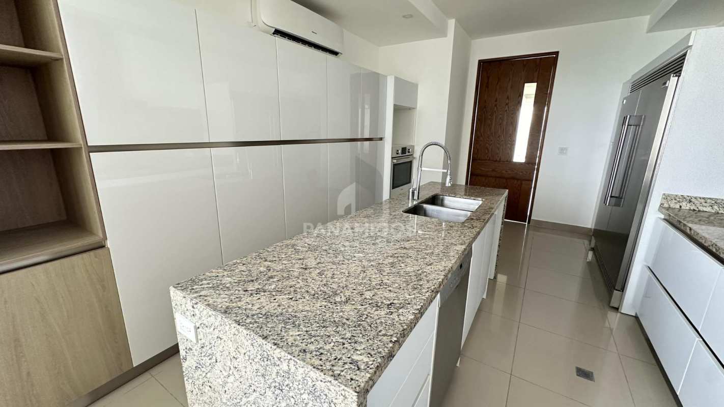 Luxury kitchen with granite counters, stainless appliances and island in PH Aria Costa del Este Panama