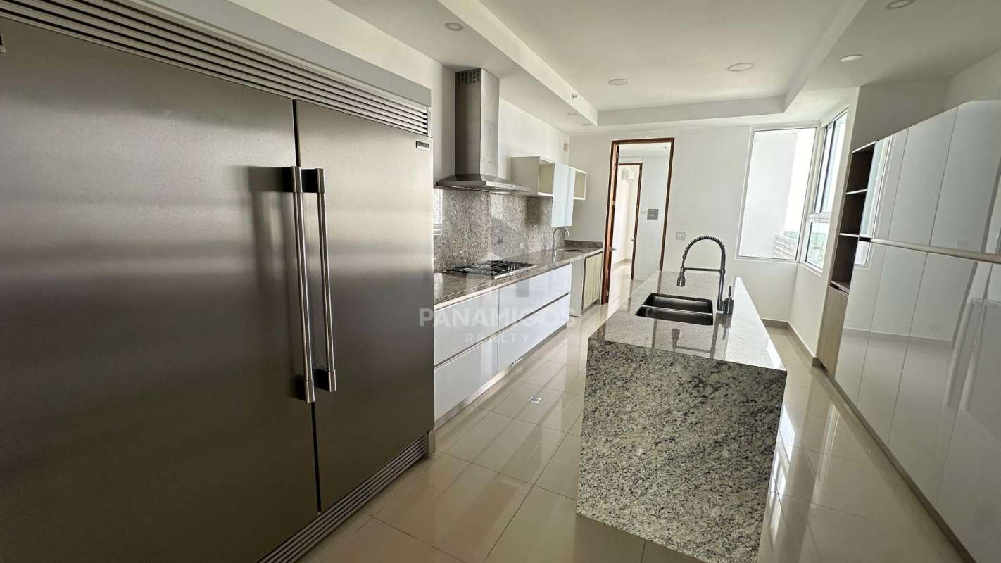 Large balcony with glass railings and ocean view in PH Aria Costa del Este Panama