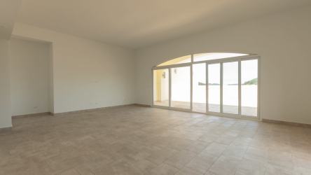 Spacious kitchen with island granite countertops white cabinetry in PH Tucan Country Panama