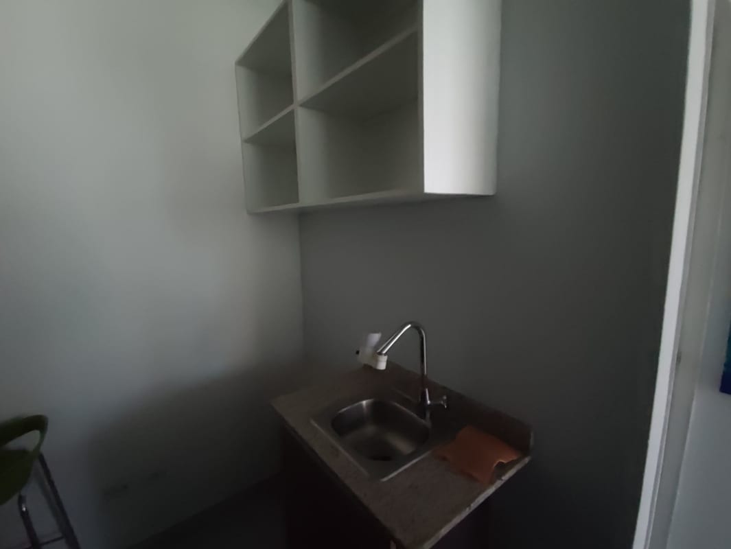 Compact kitchenette with granite countertop and shelves inside Obarrio business office space Panama