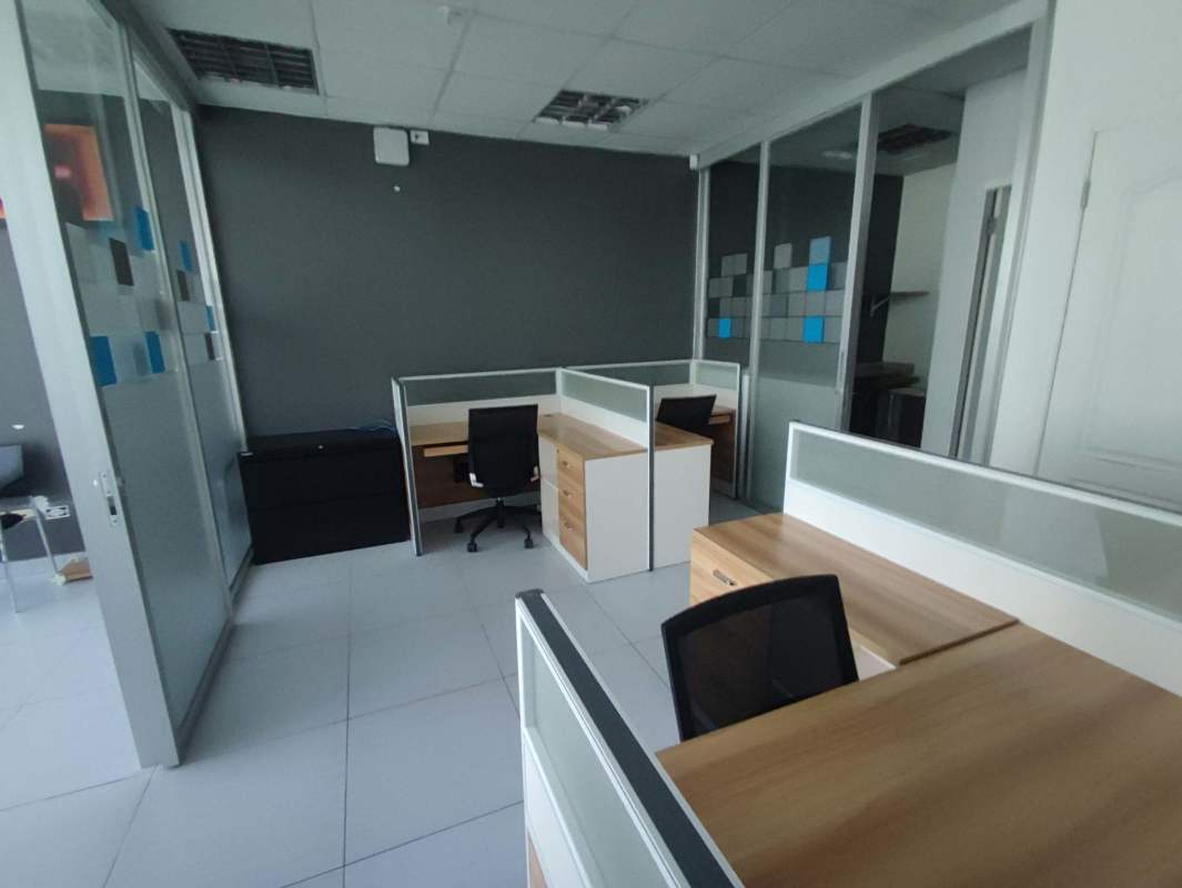 Modern minimalist elevator lobby with three elevators and tiled floors at Edificio PDC Obarrio Panama