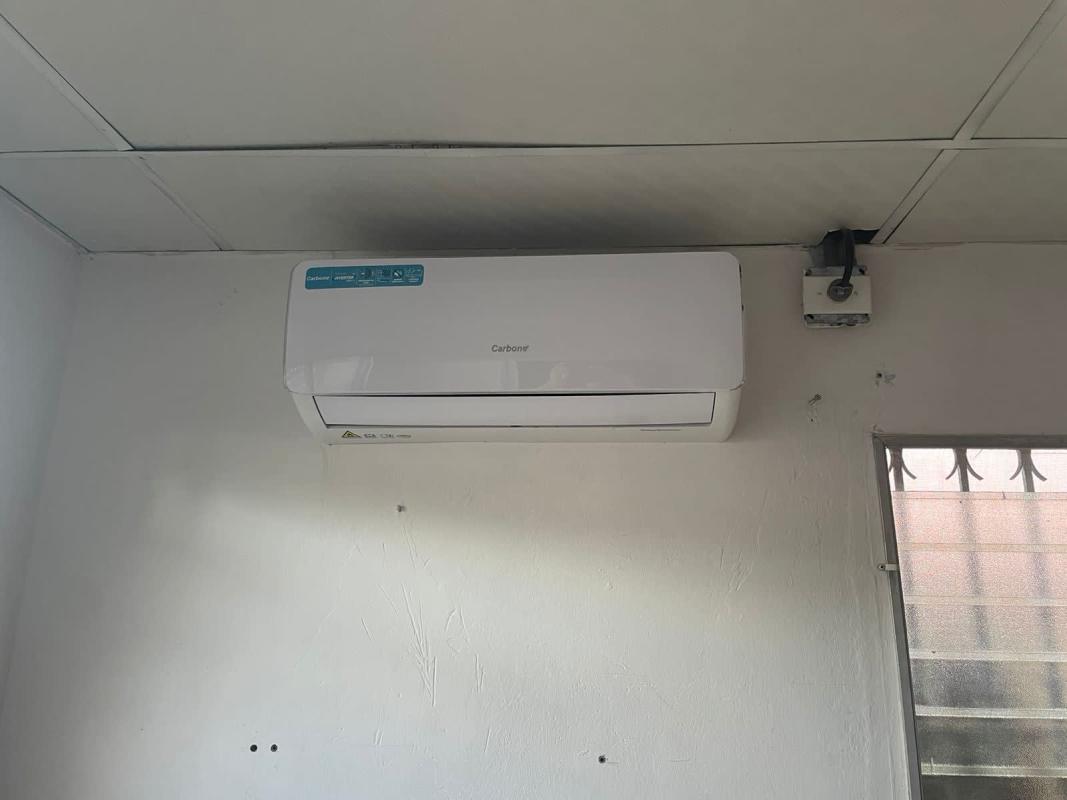 Minimalist bedroom with light blue walls, ceiling fan, tiled floor and window in Linda Vista Condado del Rey