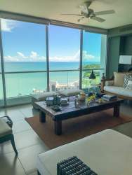 Living room with floor-to-ceiling windows ocean views PH Riomar San Carlos luxury condo Panama