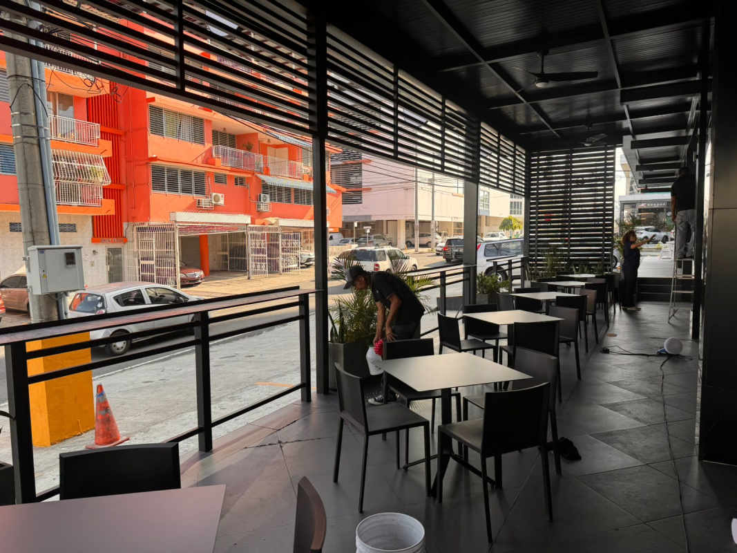 Modern shaded terrace with planters and black furniture Plaza 68 San Francisco