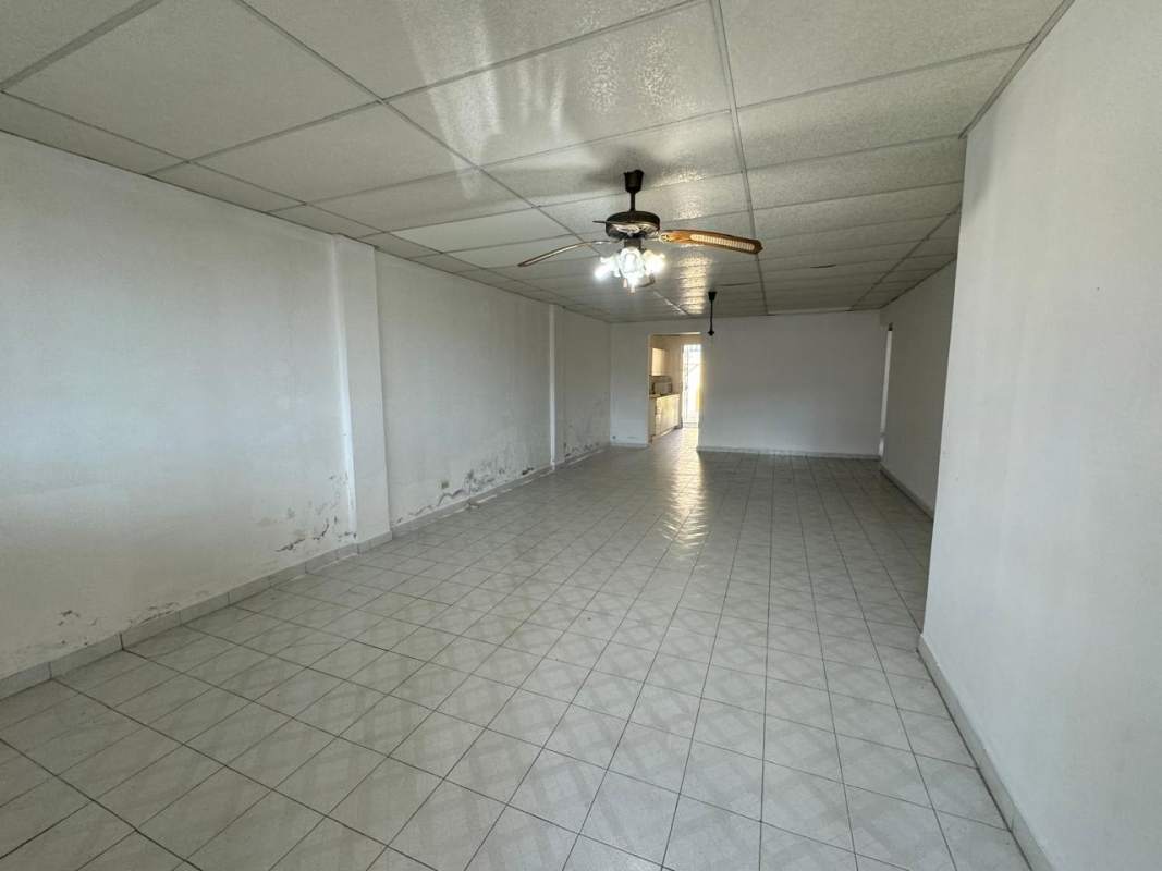 Bedroom with built-in closet, tiled floor, window security bars in Condado del Rey Panama City house