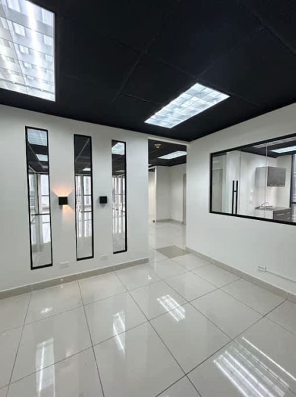 Finished commercial office with glass wall divisions tiled floor black ceiling lighting Plaza Banco General Panama Panama City