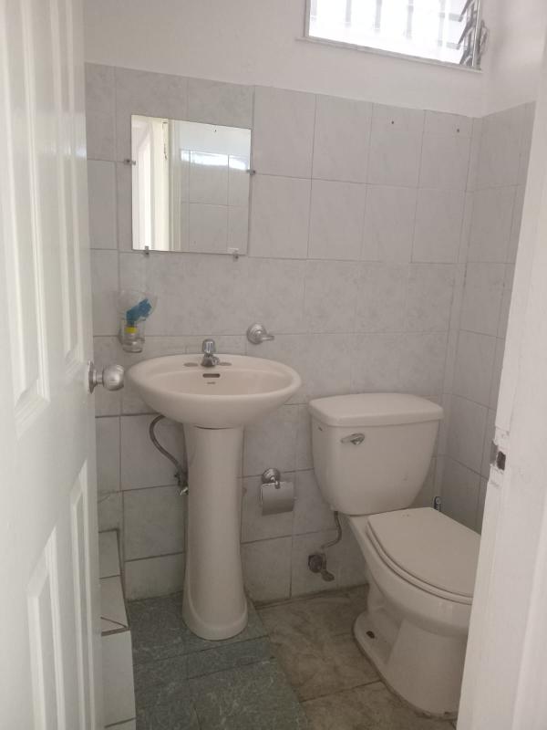 Office with windows, air conditioning unit, tiled floor, desk and chairs in commercial property Panama City