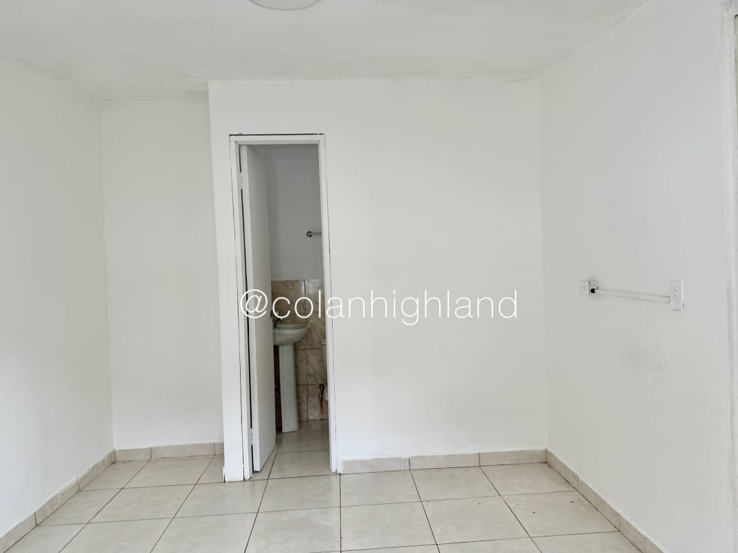 Empty bright bedroom with tiled floors and large windows in house at Hato Pintado Panama City