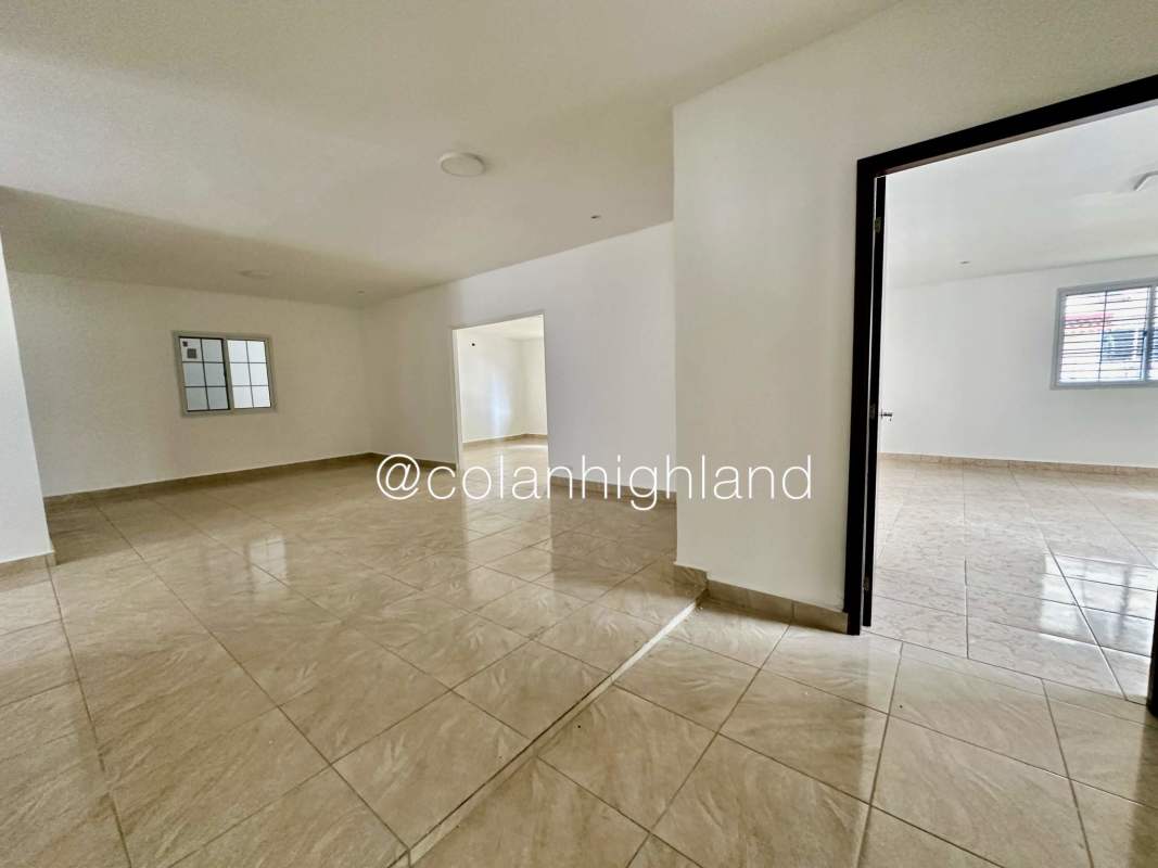 Spacious tiled open living/dining area with neutral colors in Panama house