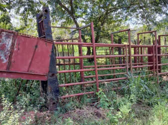 Rusted cattle handling chute with vegetation Ollas Abajo ranch Chorrera Panama