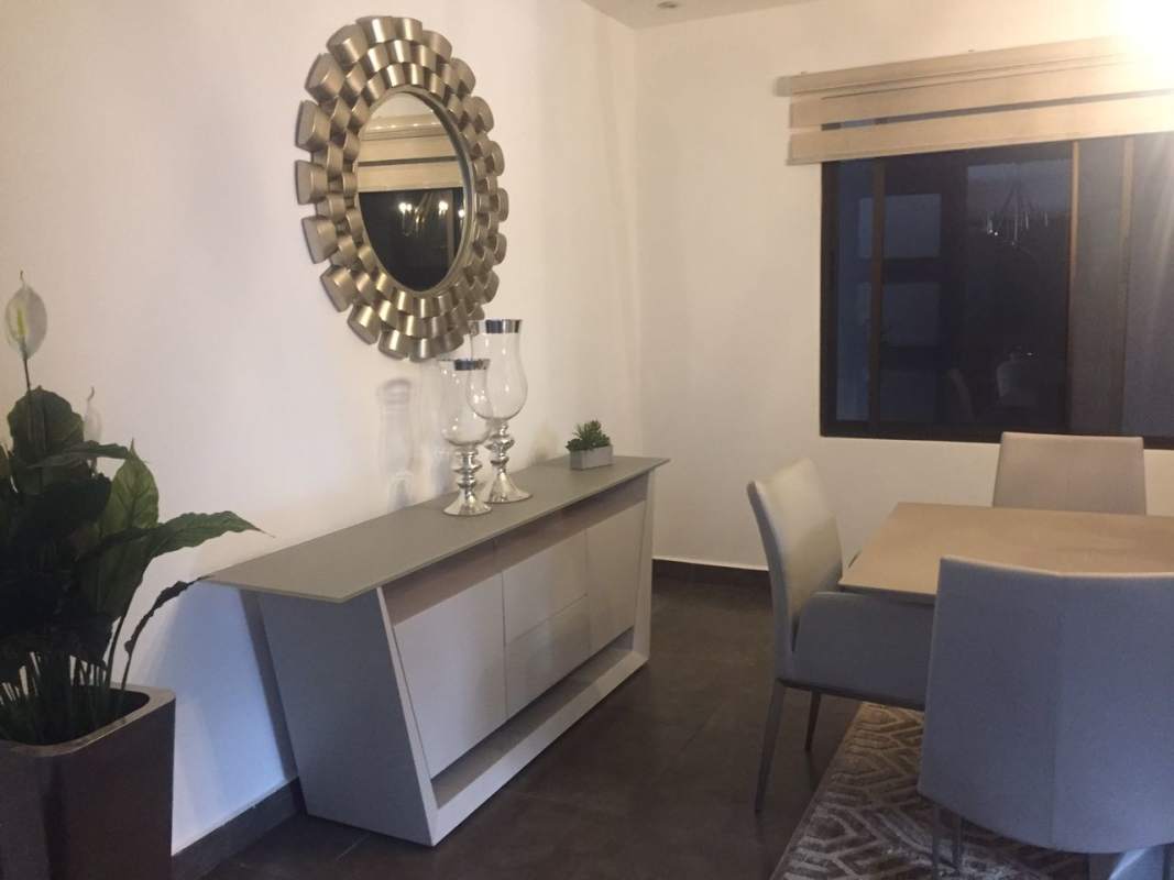 Bright modern dining area with mirror accent and window in Altos de Panamá home for sale