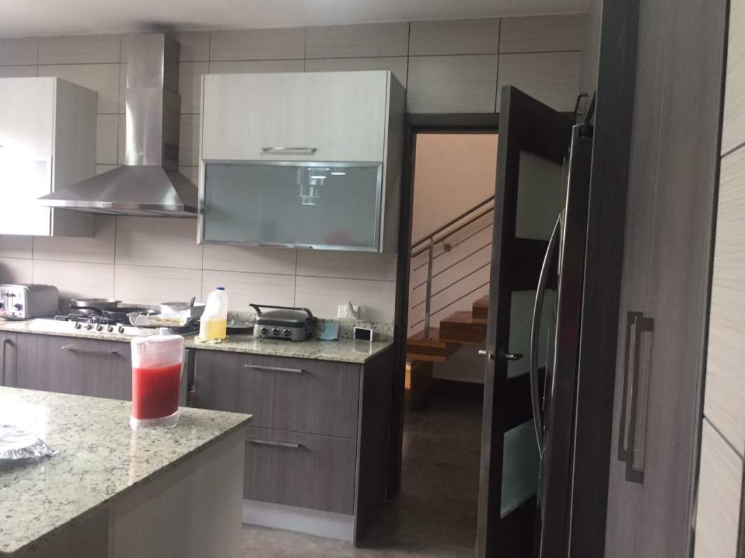 Open living room with staircase, art, and ample light in Altos de Panamá residence Panama City