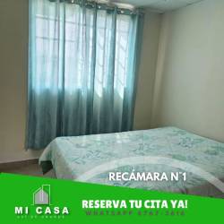 Bedroom with large window, blue curtains, tile floor in Penonomé house