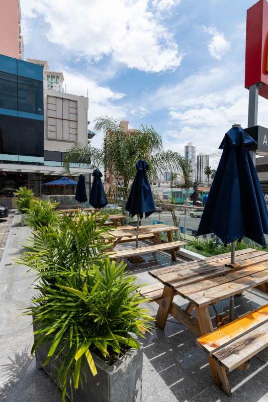 Street perspective of Royal Blue Plaza with parking and glass balconies Panama City