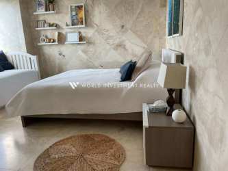 Spacious open plan living dining area with ocean views, marble tiles and large windows Royal Palm Gorgona